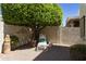Secluded backyard retreat with shaded seating area and lush greenery, providing a serene outdoor space at 9484 N 105Th Pl, Scottsdale, AZ 85258