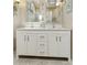 Clean bathroom with dual sinks, white cabinets, and plenty of counter space at 9484 N 105Th Pl, Scottsdale, AZ 85258
