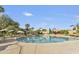 Large community pool with umbrellas and lounge chairs, providing a perfect spot for relaxation and recreation at 9484 N 105Th Pl, Scottsdale, AZ 85258