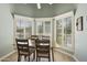 Dining area featuring bay windows with plantation shutters and stylish light fixture at 9484 N 105Th Pl, Scottsdale, AZ 85258