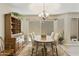 Traditional dining room featuring a wooden table, hutch, and sliding glass doors to a private patio at 9484 N 105Th Pl, Scottsdale, AZ 85258