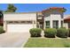 Charming single-story home featuring a well-manicured lawn, stucco exterior, and a two-car garage at 9484 N 105Th Pl, Scottsdale, AZ 85258
