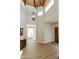 Inviting foyer with wood floors, a vaulted ceiling, and a wooden dresser at 9484 N 105Th Pl, Scottsdale, AZ 85258
