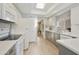 Well-lit kitchen with updated appliances and flooring, and a view to another room at 9484 N 105Th Pl, Scottsdale, AZ 85258