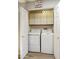 Convenient laundry room featuring a washer, dryer, and overhead storage cabinets for all your laundry essentials at 9484 N 105Th Pl, Scottsdale, AZ 85258