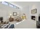 Bright and airy living room with a fireplace, neutral decor, and modern windows at 9484 N 105Th Pl, Scottsdale, AZ 85258