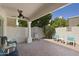 Covered patio with ceiling fan and stylish seating, perfect for outdoor relaxation and entertaining at 9484 N 105Th Pl, Scottsdale, AZ 85258