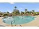 Large community pool surrounded by lounge chairs and well-maintained landscaping at 9484 N 105Th Pl, Scottsdale, AZ 85258