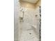 Modern shower featuring stylish tile work, multiple shower heads, and a built-in bench at 9484 N 105Th Pl, Scottsdale, AZ 85258