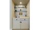 Home wet bar featuring upper shelving, storage cabinets, and a stainless steel sink at 9484 N 105Th Pl, Scottsdale, AZ 85258