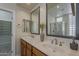 Modern bathroom featuring dual sinks, tile flooring, framed mirrors, and upgraded fixtures at 9562 E Cavalry Dr, Scottsdale, AZ 85262