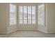 Bright bedroom featuring plantation shutters, neutral carpet, and a cozy atmosphere at 9562 E Cavalry Dr, Scottsdale, AZ 85262