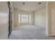 Spacious bedroom featuring neutral carpet, a ceiling fan, plantation shutters, and sliding glass door at 9562 E Cavalry Dr, Scottsdale, AZ 85262