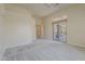 Open bedroom featuring neutral carpet, a ceiling fan, and sliding glass doors to the backyard at 9562 E Cavalry Dr, Scottsdale, AZ 85262
