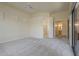 Spacious bedroom with neutral carpet, a ceiling fan, and access to the en-suite bathroom at 9562 E Cavalry Dr, Scottsdale, AZ 85262