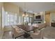 Stylish dining area with modern chandelier adjacent to the living room at 9562 E Cavalry Dr, Scottsdale, AZ 85262