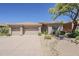 Charming desert home featuring a three-car garage and drought-resistant landscaping at 9562 E Cavalry Dr, Scottsdale, AZ 85262
