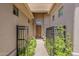 Inviting front entrance with gated courtyard and lush greenery at 9562 E Cavalry Dr, Scottsdale, AZ 85262