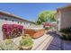 Backyard with hot tub, landscaping, mature trees, and privacy wall at 9562 E Cavalry Dr, Scottsdale, AZ 85262