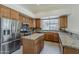 Updated kitchen featuring stainless appliances, granite counters and central island at 9562 E Cavalry Dr, Scottsdale, AZ 85262