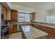 Updated kitchen with granite countertops, wood cabinets, stainless steel appliances, and lots of natural light at 9562 E Cavalry Dr, Scottsdale, AZ 85262