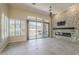 Open living room with stone fireplace and sliding glass doors to backyard at 9562 E Cavalry Dr, Scottsdale, AZ 85262