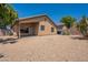 Backyard view showing a covered patio, gravel landscape, and block wall for privacy at 10649 W Alvarado Rd, Avondale, AZ 85392