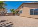 The backyard features gravel landscaping, a covered patio, and a block wall for privacy at 10649 W Alvarado Rd, Avondale, AZ 85392