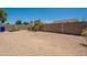 View of a gravel landscaped backyard with block wall that offers privacy and low maintenance at 10649 W Alvarado Rd, Avondale, AZ 85392
