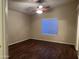 Bedroom with modern ceiling fan, window with blinds, and stylish dark wood-look flooring at 10649 W Alvarado Rd, Avondale, AZ 85392