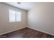 Cozy bedroom features wood-look floors and a window for natural lighting at 10649 W Alvarado Rd, Avondale, AZ 85392