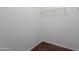 Walk-in closet featuring built-in shelving and laminate flooring at 10649 W Alvarado Rd, Avondale, AZ 85392