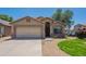 Welcoming single-story home with a two-car garage and attractive desert landscaping on a sunny day at 10649 W Alvarado Rd, Avondale, AZ 85392