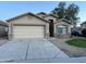 Charming single-story home with a two-car garage and desert landscaping under a clear sky at 10649 W Alvarado Rd, Avondale, AZ 85392