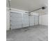 A spacious garage with a gray automatic door and ample room for vehicles and storage at 10649 W Alvarado Rd, Avondale, AZ 85392