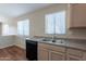 A functional kitchen featuring standard appliances, laminate flooring, and natural lighting at 10649 W Alvarado Rd, Avondale, AZ 85392