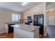 Spacious kitchen features an island, modern appliances, and ample cabinet space for storage at 10649 W Alvarado Rd, Avondale, AZ 85392