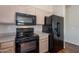 Clean kitchen featuring essential appliances, wood cabinets, and neutral countertops for easy maintenance at 10649 W Alvarado Rd, Avondale, AZ 85392