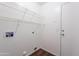 A functional laundry room with built-in shelving and connections for washer and dryer at 10649 W Alvarado Rd, Avondale, AZ 85392