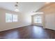 Inviting living space with laminate wood floors, large windows, and a neutral color palette for easy customization at 10649 W Alvarado Rd, Avondale, AZ 85392