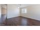 A well-lit living room featuring laminate wood flooring and a neutral color scheme to personalize and enjoy at 10649 W Alvarado Rd, Avondale, AZ 85392