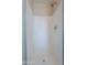 Shower features a tiled surround and modern shower head in this bright, clean bathroom at 10649 W Alvarado Rd, Avondale, AZ 85392