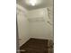 A well-organized walk-in closet with wire shelving and wood-look flooring at 10649 W Alvarado Rd, Avondale, AZ 85392