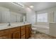 This bathroom has a dual sink vanity, soaking tub, and a separate shower, perfect for relaxation at 11016 W Griswold Rd, Peoria, AZ 85345
