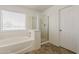 This bathroom offers a large soaking tub, glass shower, and a window that provides natural light at 11016 W Griswold Rd, Peoria, AZ 85345