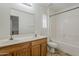 Bright bathroom features double sinks, wood cabinets, and a shower-tub combination at 11016 W Griswold Rd, Peoria, AZ 85345