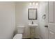 Powder room features a decorative pedestal sink and a stylish framed mirror at 11016 W Griswold Rd, Peoria, AZ 85345