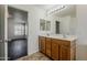 This bathroom features dual sinks and is connected to a bedroom through an open doorway at 11016 W Griswold Rd, Peoria, AZ 85345