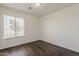 This bedroom features wood-look floors, a window that provides natural light, and neutral paint at 11016 W Griswold Rd, Peoria, AZ 85345