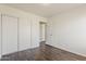 This bedroom boasts wood-look floors, sliding closet doors, and an open entry doorway at 11016 W Griswold Rd, Peoria, AZ 85345